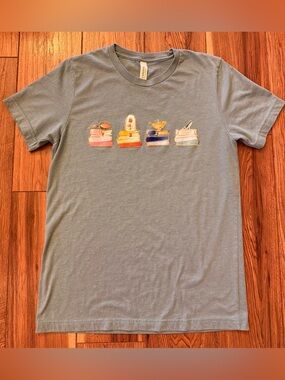 Bella Canvas light blue short tee with colorful Disney book stack graphic